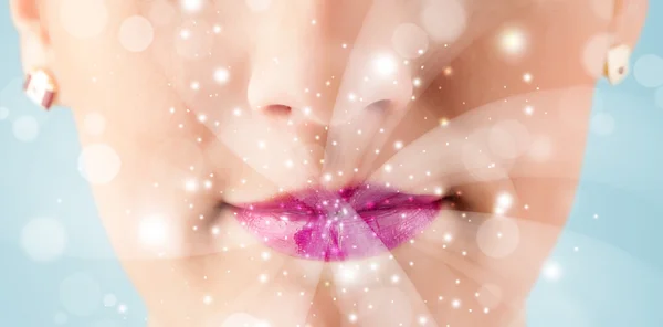 Pretty woman lips blowing abstract white lights — Stock Photo, Image