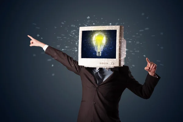 Business man with a pc monitor head and idea light bulb in the d — Stock Photo, Image