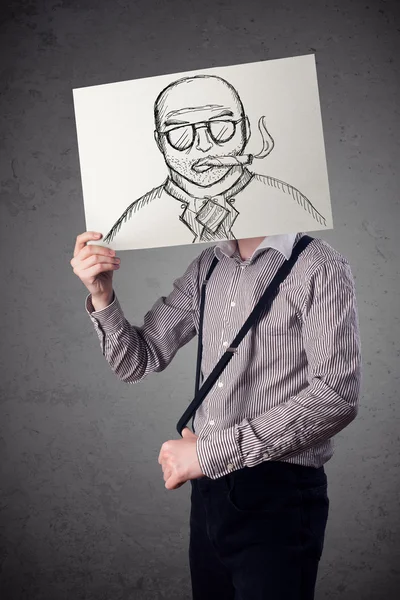 Businessman holding a cardboard with a smoking man on it in fron — Stock Photo, Image