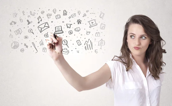 Young woman drawing and sketching icons and symbols — Stock Photo, Image