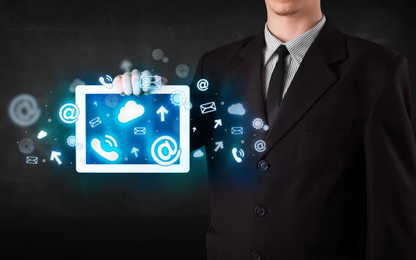 Person holding a tablet with blue technology icons and symbols — Stock Photo, Image