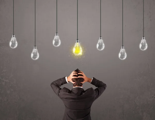 Businness guy in front of idea light bulbs concept — Stock Photo, Image