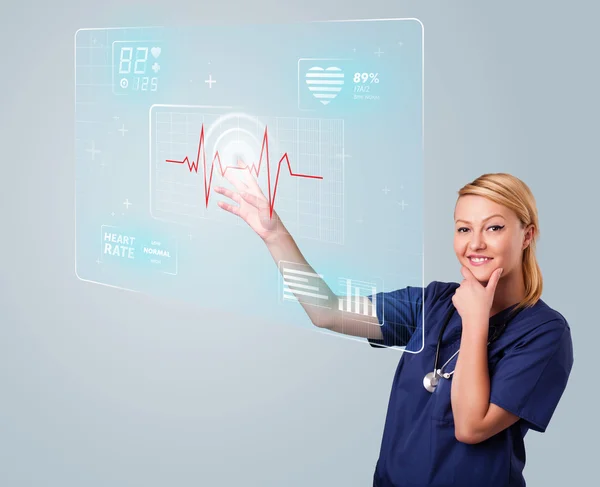 Young nurse pressing modern medical type of buttons — Stock Photo, Image