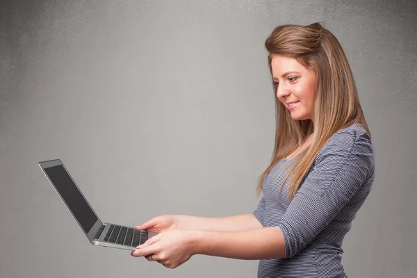 Young woman holding modern laptot — Stock Photo, Image