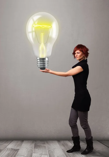 Beautiful lady holding realistic 3d light bulb — Stock Photo, Image