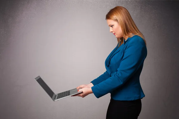 Young woman holding modern laptot — Stock Photo, Image