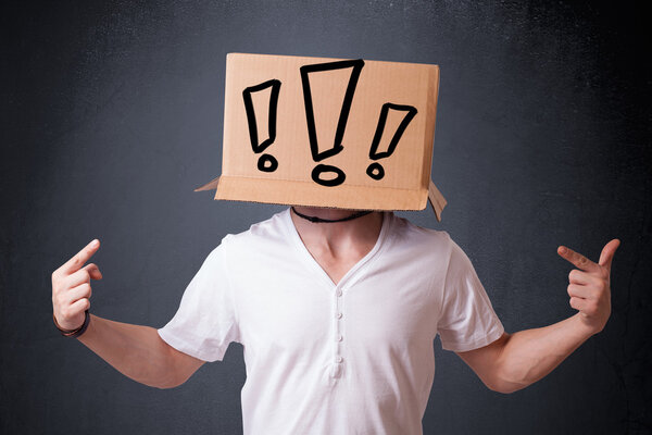 Молодой человек жестом с картонной коробкой на голове с восторгом
