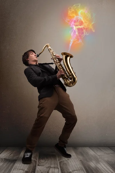 Attractive musician playing on saxophone with colorful abstract — Stock Photo, Image