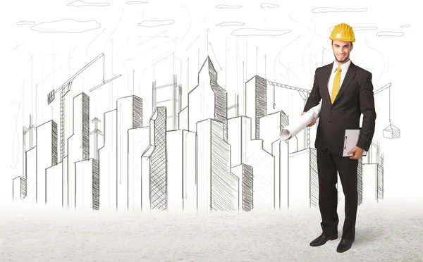 Engineer man with building city drawing in background — Stock Photo, Image
