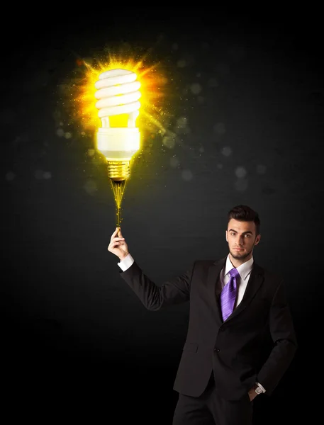 Businessman with an eco-friendly bulb — Stock Photo, Image