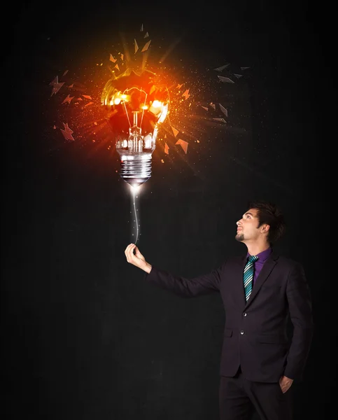 Businessman with an explosion bulb — Stock Photo, Image