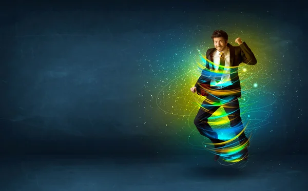 Emocionado hombre de negocios saltando con líneas de colores de energía — Foto de Stock