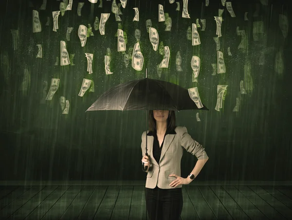 Businesswoman standing with umbrella in dollar bill rain concept — Stock Photo, Image