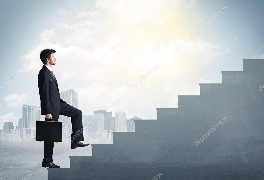 Businessman climbing up a concrete staircase concept