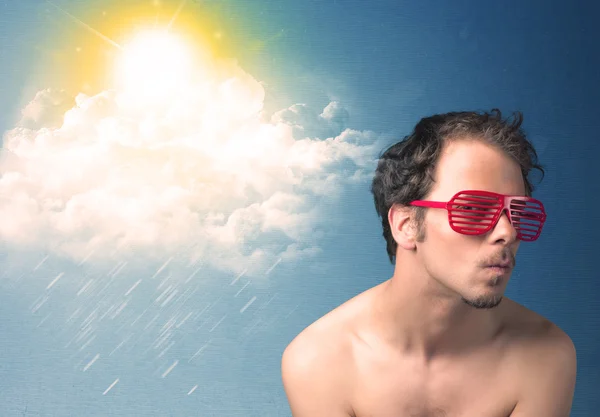 Young person looking with sunglasses at clouds and sun — Stock Photo, Image