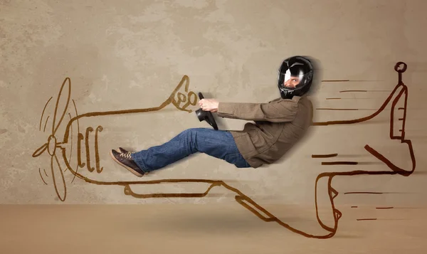 Funny pilot driving a hand drawn airplane on the wall — Stock Photo, Image