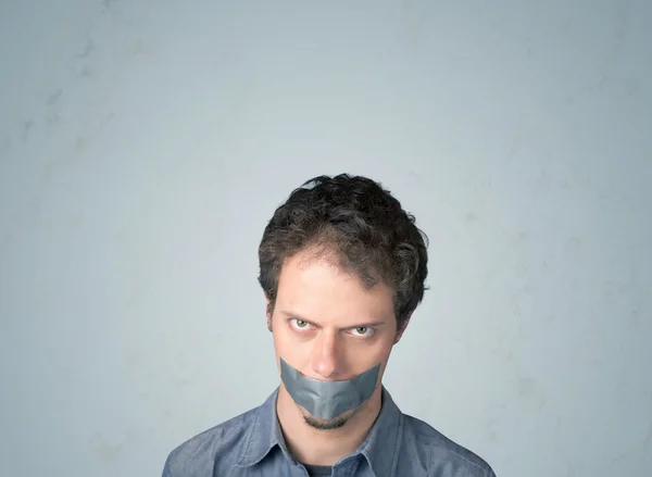 Young man with glued mouth — Stock Photo, Image