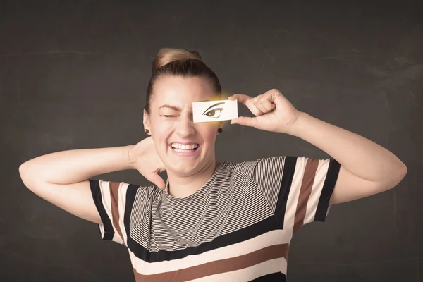 Joven guay mirando con un papel dibujado a mano ojos — Foto de Stock