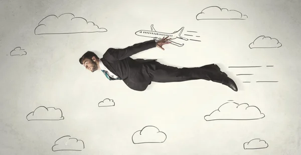 Cheerful business person flying between hand drawn sky clouds — Stock Photo, Image