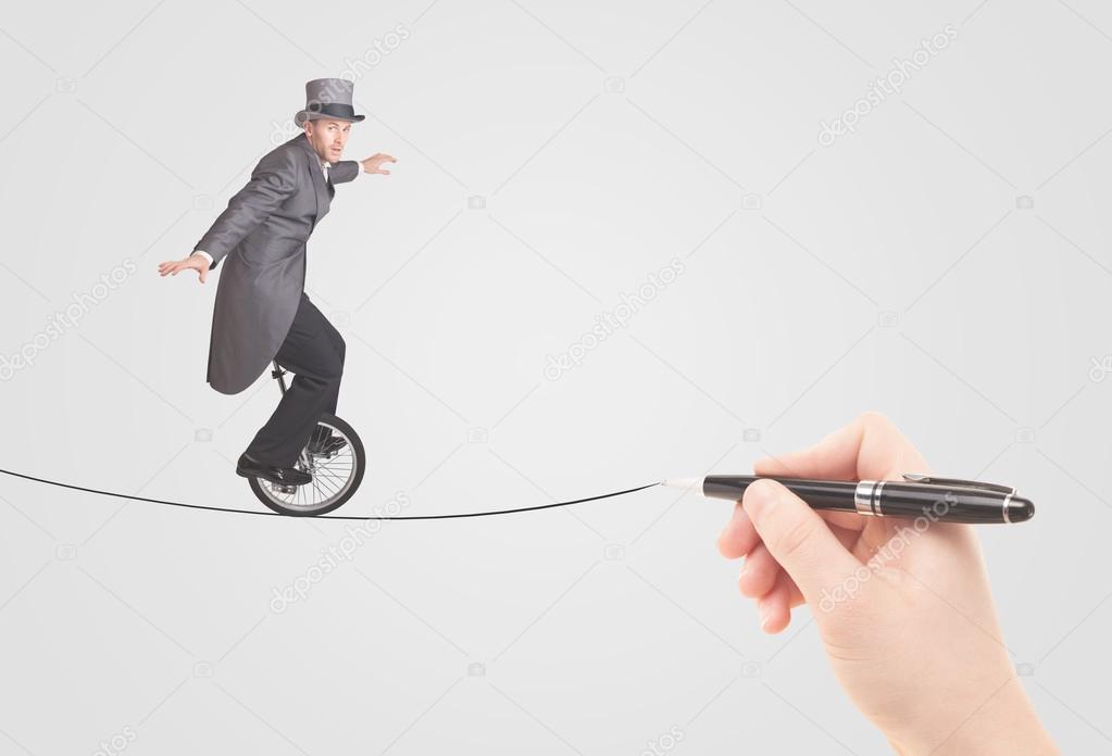 Businessman riding monocycle on a rope drawn by hand