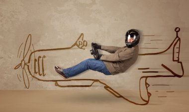 Duvara el çizimi uçak süren komik pilot.
