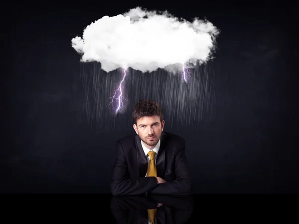 Depressed businessman sitting under a cloud — Stock Photo, Image