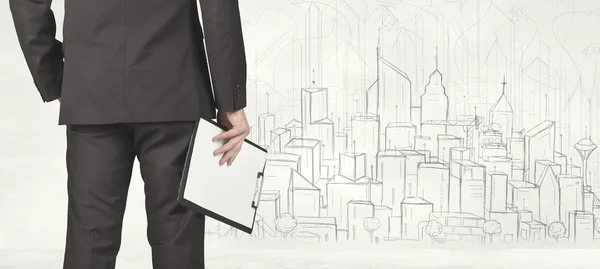 Businessman with drawn city view — Stock Photo, Image