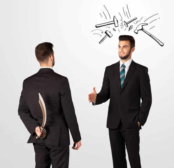 Businessman hiding a weapon — Stock Photo, Image