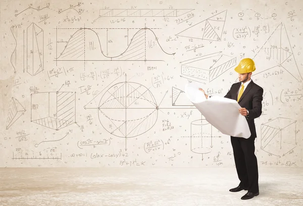 Handsome engineer calculating with hand drawn background — Stock Photo, Image