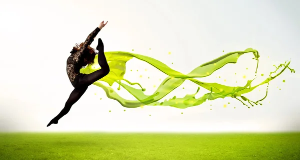 Pretty girl jumping with green abstract liquid dress — Stock Photo, Image