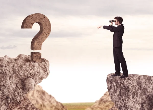 Businessman on rock mountain with a question mark — Stock Photo, Image