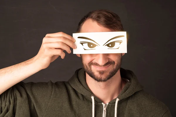 Cool youngster looking with a paper hand drawn eyes — Stock Photo, Image