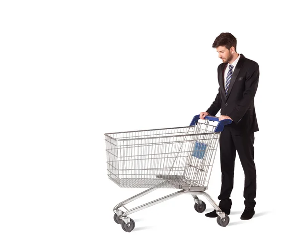 Businessman with shopping cart Royalty Free Stock Photos