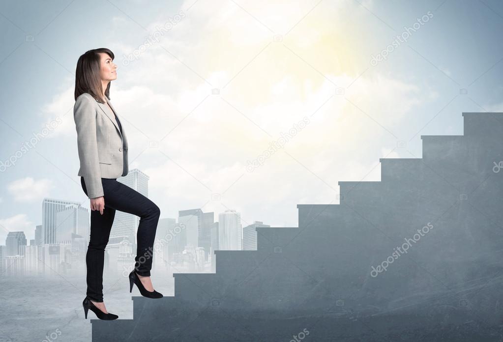 Businesswoman climbing up a concrete staircase concept