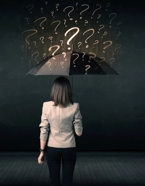 Businesswoman with umbrella and a lot of drawn question marks — Stock Photo, Image