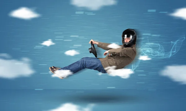 Funny racedriver young man driving between clouds concept — Stock Photo, Image