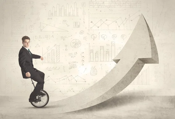 Happy business man riding a monocycle up on an arrow — Stock Photo, Image