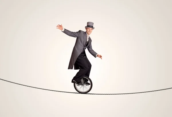 Extreme business man riding unicycle on a rope — Stock Photo, Image