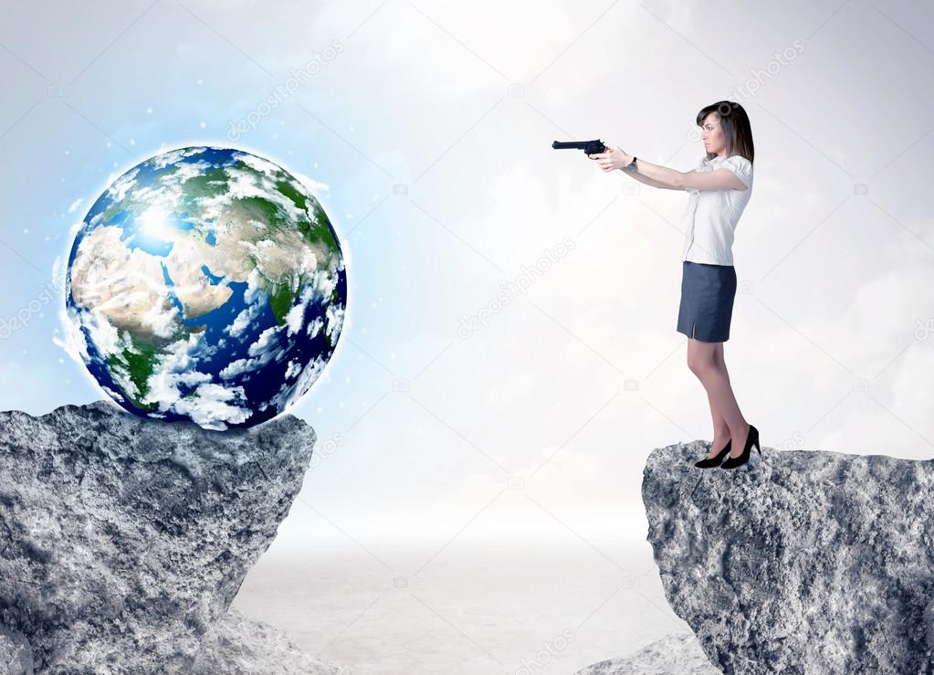 Businesswoman on rock mountain with a globe