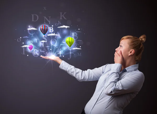 Letters and balloons in the hand of a businesswoman — Stock Photo, Image