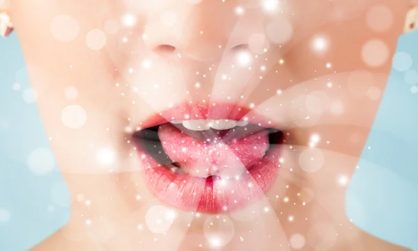 Pretty woman lips blowing abstract white lights — Stock Photo, Image