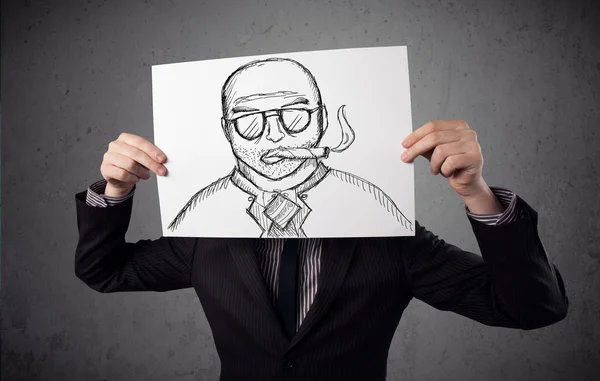 Businessman holding a cardboard with a smoking man on it in fron — Stock Photo, Image