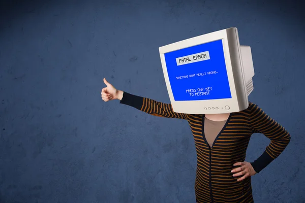 Person with a monitor head and fatal error blue screen on the di — Stock Photo, Image