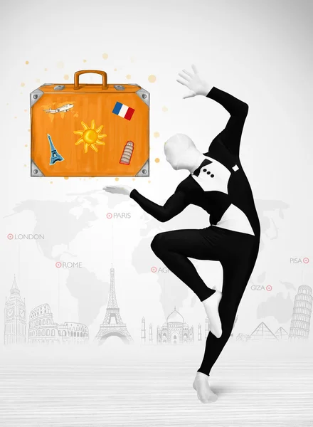 Man in full body suit presenting vacation suitcase — Stock Photo, Image