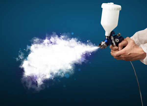 Painter with airbrush gun and white magical smoke — Stock Photo, Image