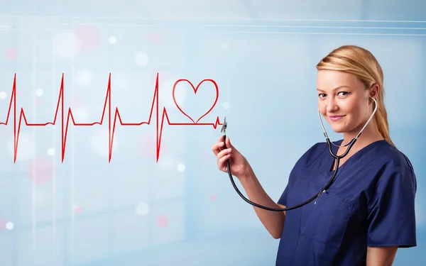 Young nurse listening to abstract pulse with red heart — Stock Photo, Image