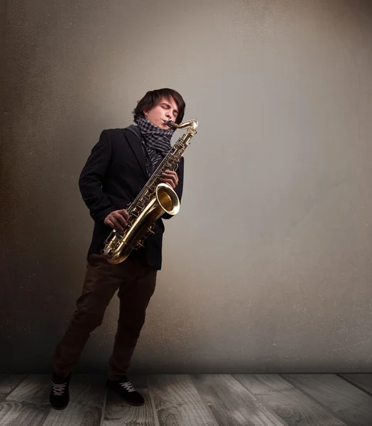 Young musician playing on saxophone — Stock Photo, Image