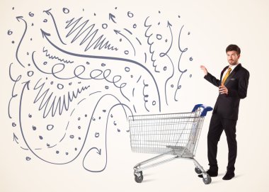 Alışveriş arabalı bir iş adamı.