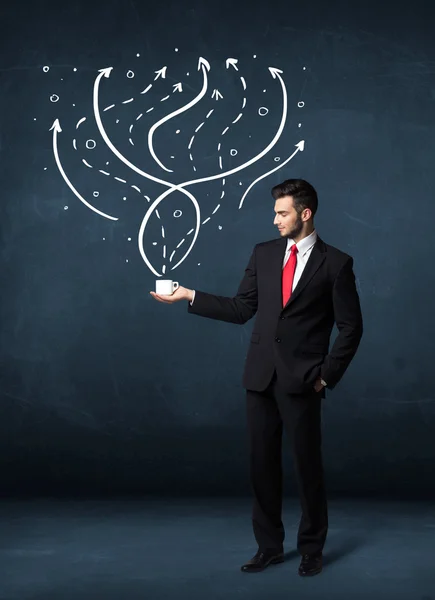 Businessman holding a white cup with lines and arrows — Stock Photo, Image