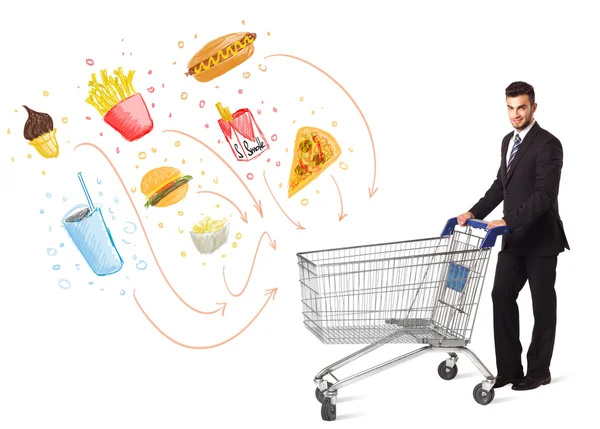 Man with shopping cart with toxic junk food — Stock Photo, Image